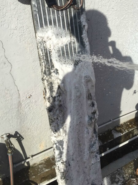 Washing away the chemical applied on the aircon evaporator