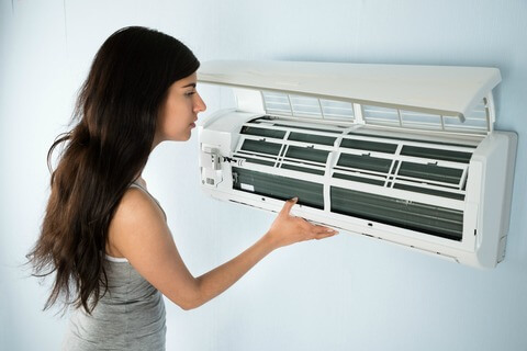 Women checking her aircon unit